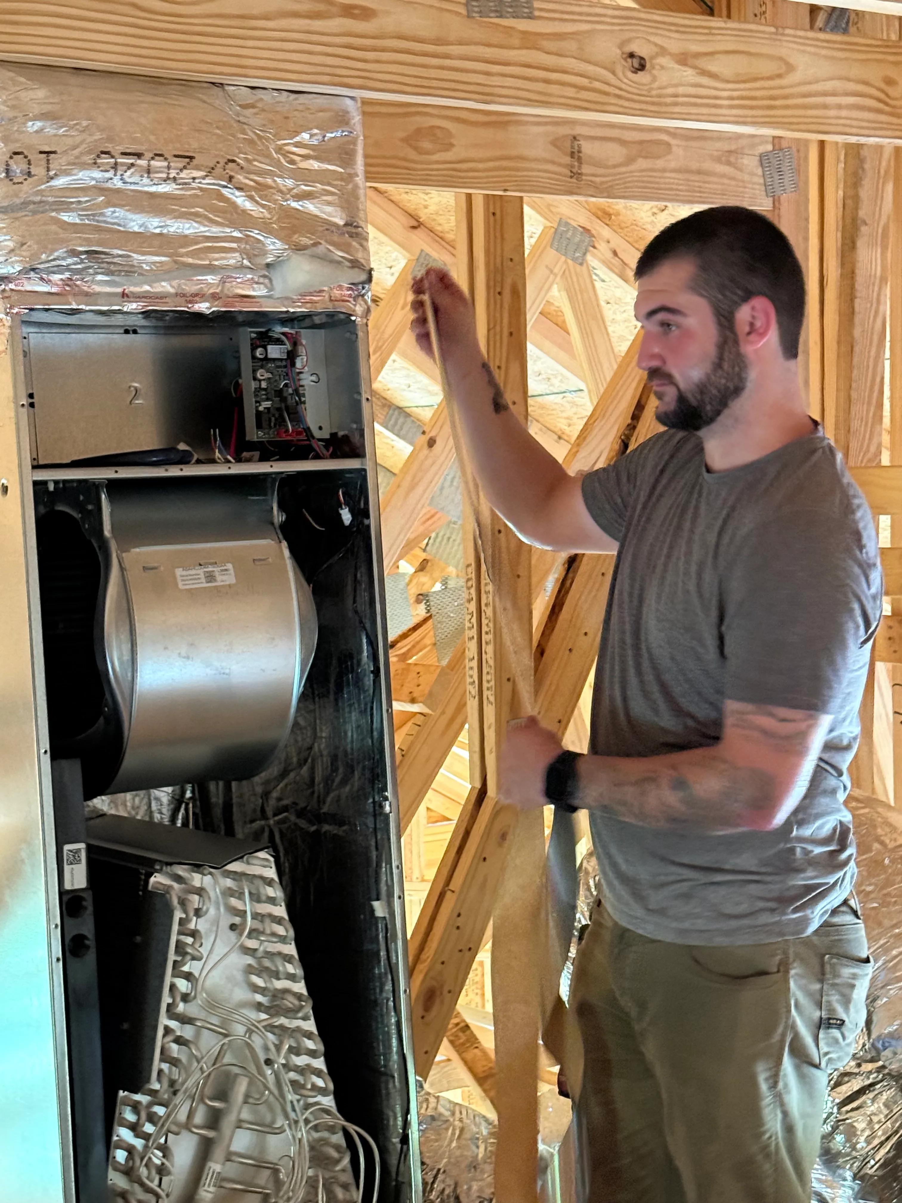 East Tennessee Air Company technician installing an air handler in the attic of a new construction home in Knoxville, TN