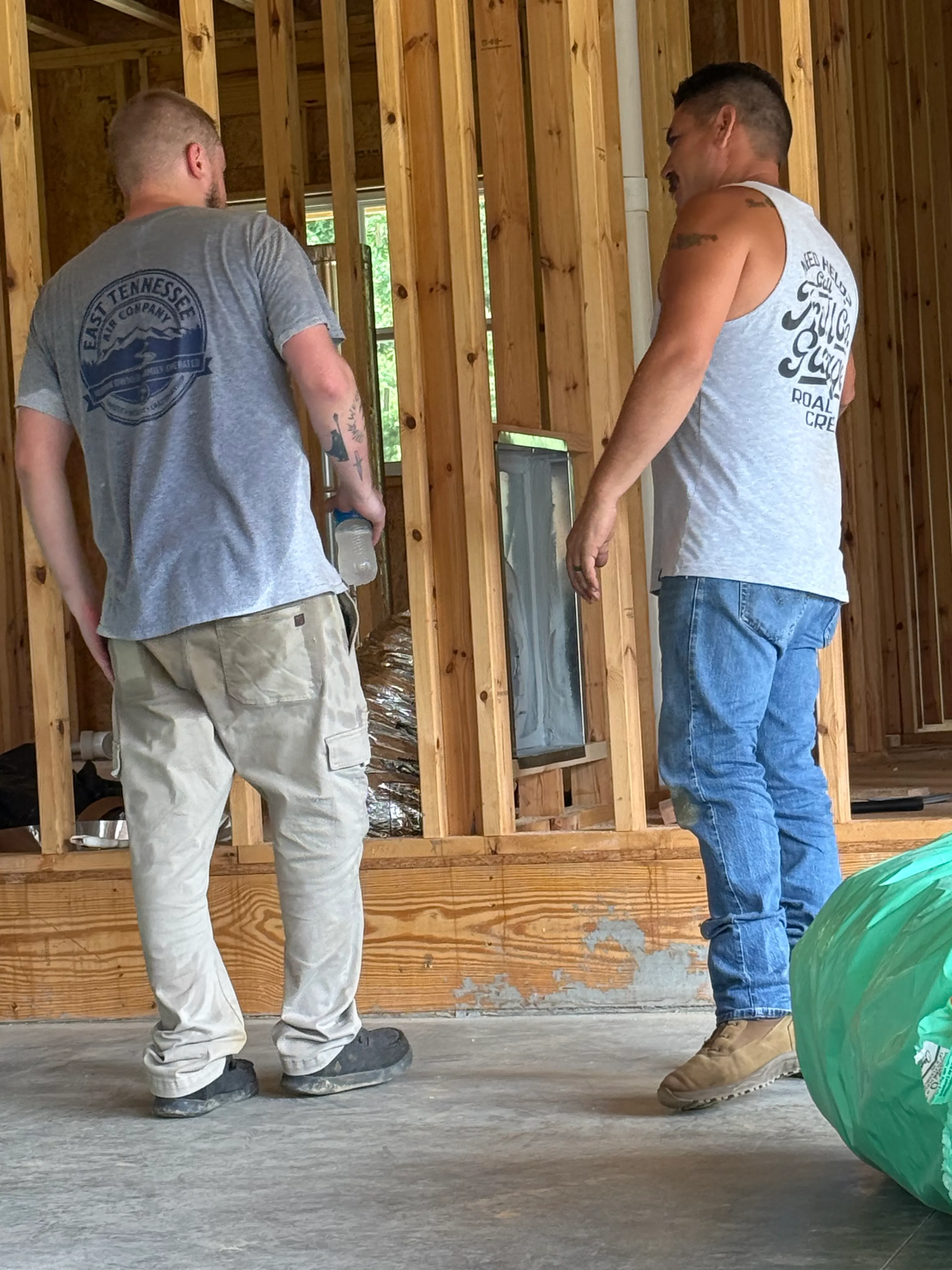 East Tennessee Air Company technicians installing HVAC ductwork between floor joists in a new construction home in Knoxville, TN
