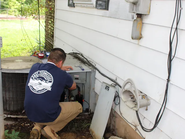 East Tennessee Air Company technician servicing an outdoor AC unit