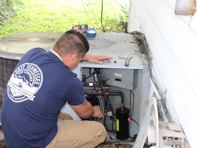 East Tennessee Air Company technician repairing an outdoor AC unit